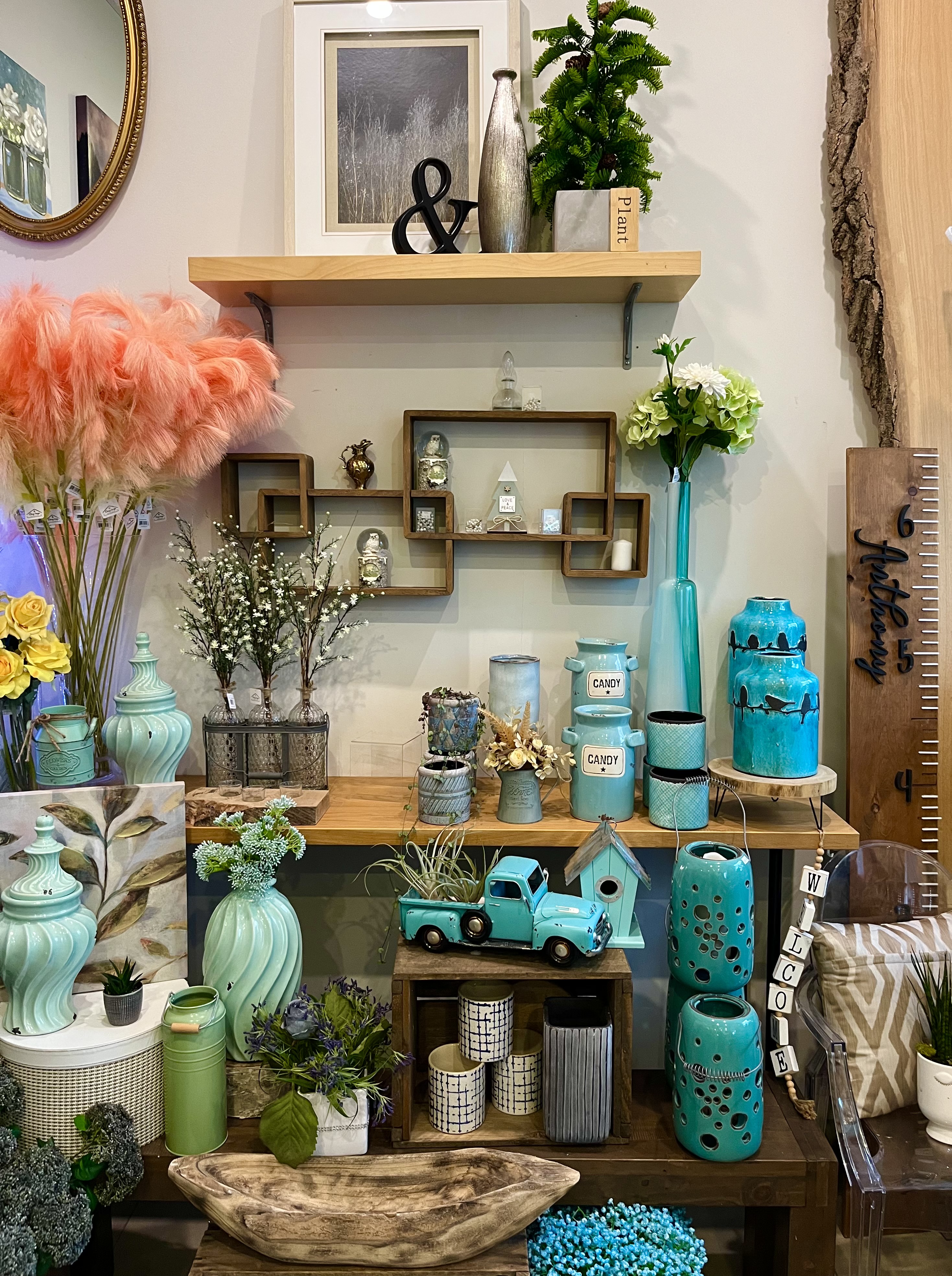 Shelves with turquoise vases, vintage finds, and pampas grass in soft natural light